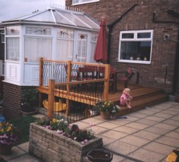 deck with wrought iron panels and smooth handrail