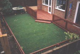simple deck with railing around lawn for protection